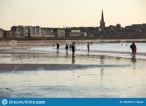 Romantic Walk Of People Before Sunset On The Picturesque Beach Of Saint