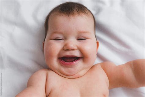Toothless Infant Baby Nude On Bed Sheet Del Colaborador De Stocksy Giorgio Magini Stocksy