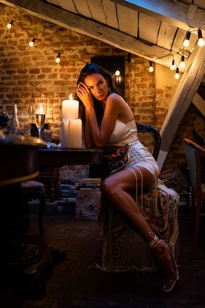 Premium Photo Woman In Cozy Evening Interior With Candles
