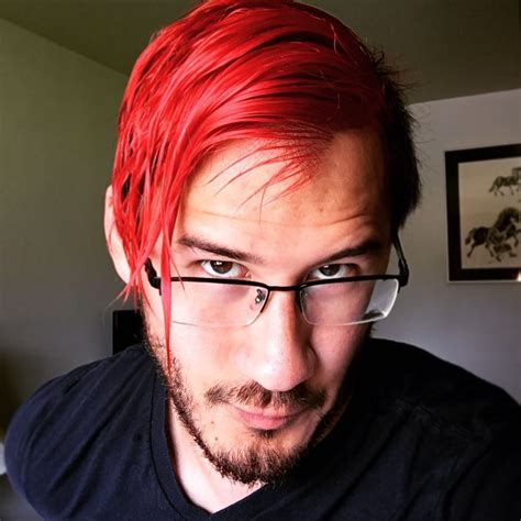 A Man With Pink Hair And Glasses Looking At The Camera