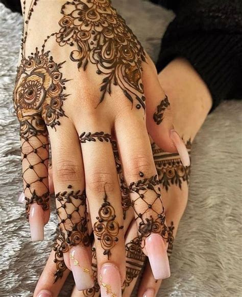 A Woman S Hand With Henna Tattoos On It
