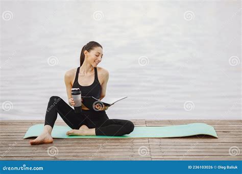 Woman Practicing Advanced Yoga By The Water Stock Photo Image Of