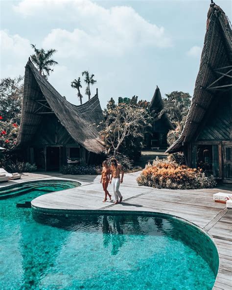 An Instagram With Two People Standing By A Swimming Pool In Front Of