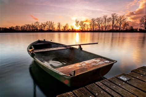 Brown Wooden Boat On Dock During Sunset · Free Stock Photo