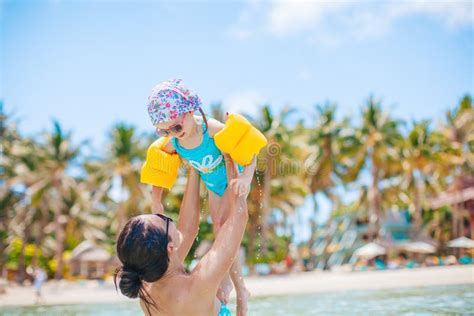 Young Beautiful Mother Having Fun With Her Daughter On Tropical Beach Vacation Stock Image