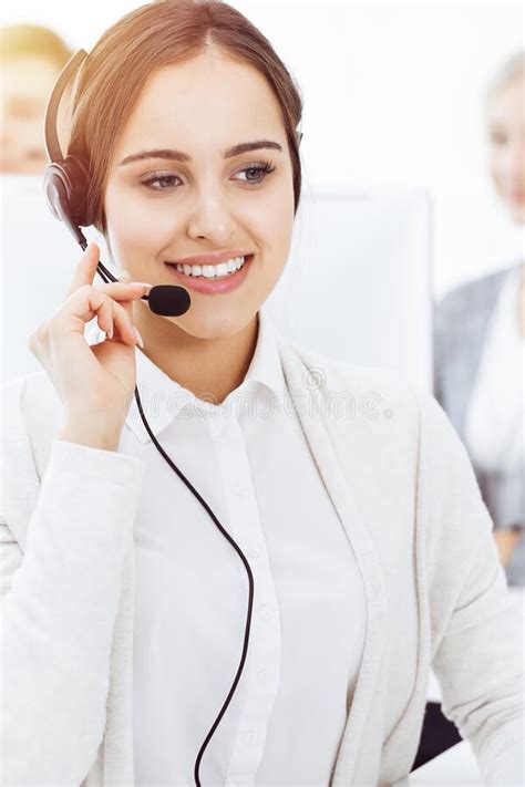 Call Center Group Of Operators At Work Focus On Beautiful Woman Receptionist In Headset At