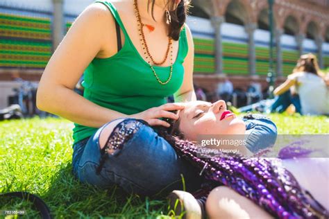 Woman Giving Friend Head Massage On Grass Milan Italy High Res Stock
