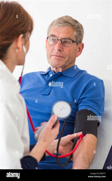 Doctor Checking The Blood Pressure Of Elderly Patient Stock Photo Alamy