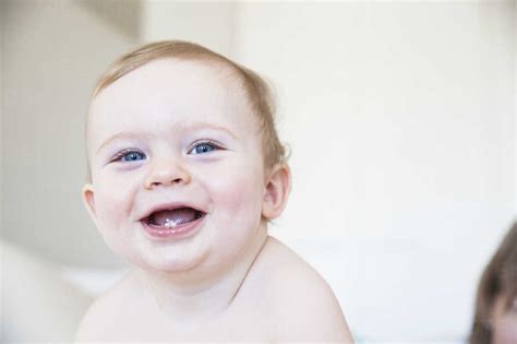 Portrait Of Happy Baby Boy On Bed Stock Photo