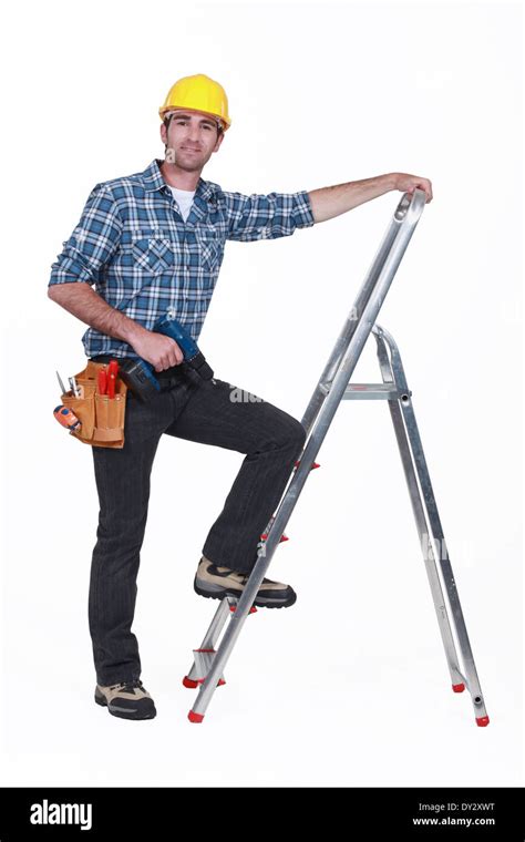 Man With Drill Climbing Ladder Stock Photo Alamy