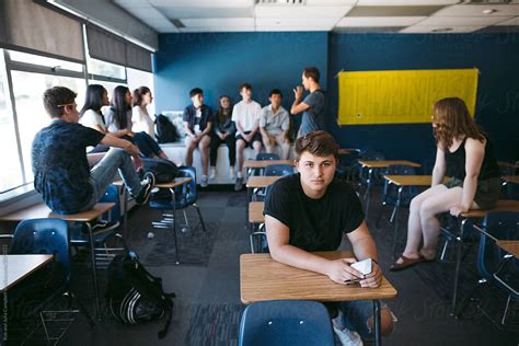 Lonely Teenage Boy Sitting In Classroom By Stocksy Contributor Rob
