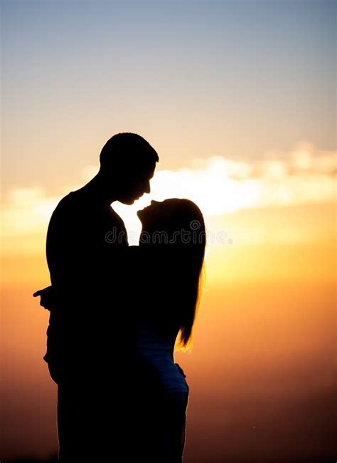 Silhouette Of Couple Kissing In Sunset Stock Photo Image 33924750