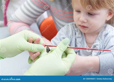 Blood Medical Test Or Research Taking A Blood Sample From Child Finger
