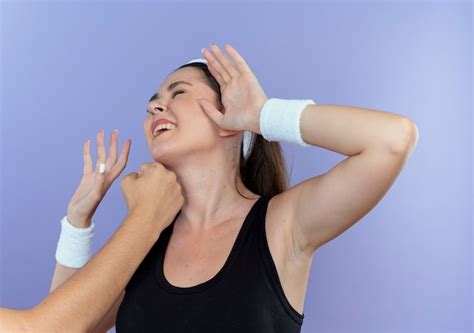 Free Photo Young Fitness Woman In Headband Being Punched With Fist In