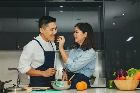 asian couple delights in cooking in the home kitchen stock image image of cuisine housewife