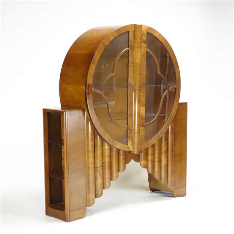 This is a fine example of the roaring 20's. Art Deco Walnut Rocket Round Display Cabinet. SOLD