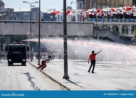 Protesters Struggling Against The Police Water Cannon While It Shoots