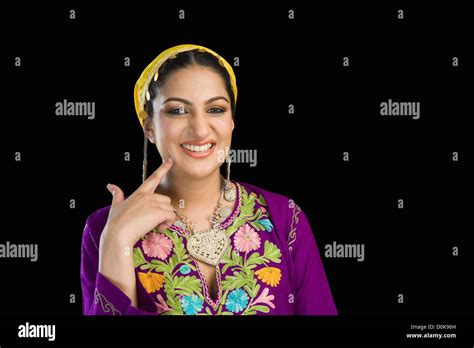 Beautiful Woman In Kashmiri Dress Smiling And Touching Her Cheek Stock