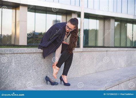 Woman Massaging Heel Suffering From Walking On High Heels Stock Image