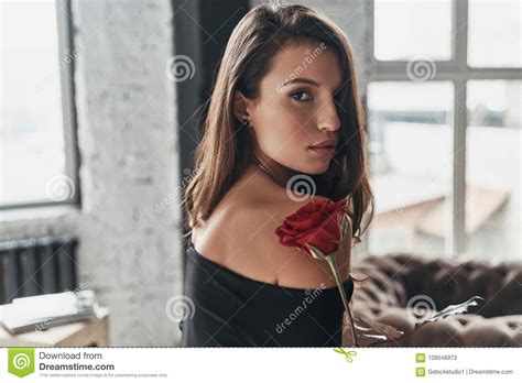 Effortless Beauty Attractive Young Woman In Elegant Black Dress Stock