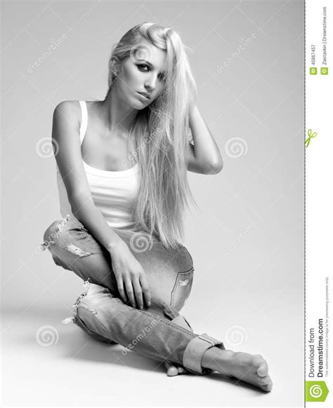 Blonde Woman In Ragged Jeans And Vest Stock Image Image Of Black Foot 45867457