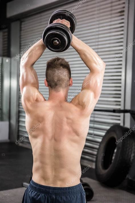 Shirtless Man Lifting Heavy Dumbbell Stock Photo By Wavebreakmedia