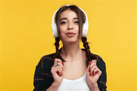 Premium Photo Woman Listens Music In White Headphones Isolated