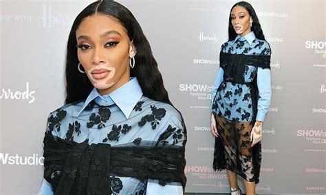 Winnie Harlow Wows In Blue Shirt With A Floral Sheer Overlay At Fashion