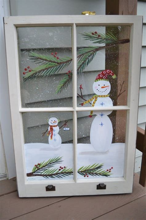 An Old Window Is Decorated With Snowmen And Pine Branches
