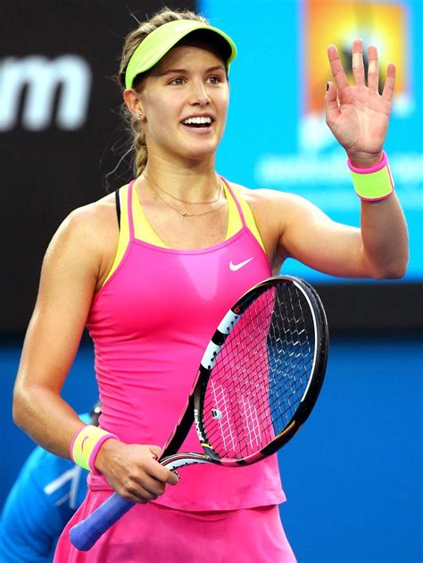 A Woman Holding A Tennis Racquet In Her Right Hand And Waving To The Crowd
