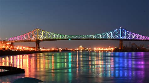 The Jacques Cartier Bridge In Montreal Is Illuminated In The Colours Of