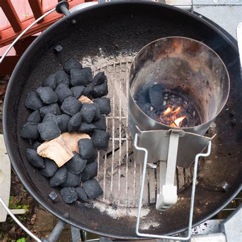 An Outdoor Grill With Charcoals Cooking On Its Side And Fire In The Middle