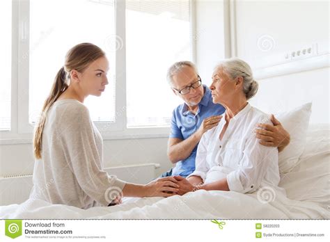 Family Visiting Ill Senior Woman at Hospital Stock Image - Image of ...