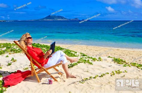Hawaii Oahu Kailua Lanikai Beach Woman On Beach Uses Electronic