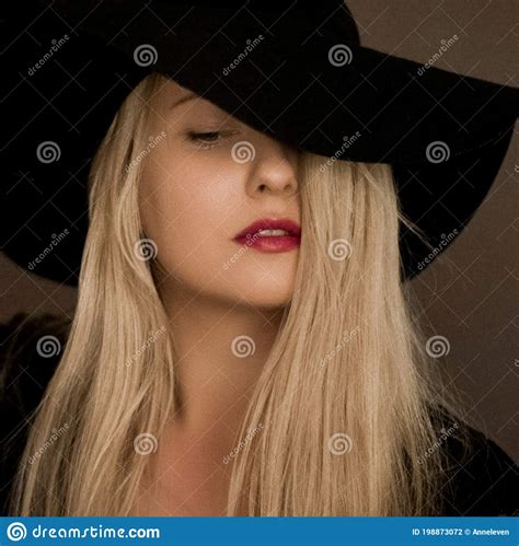 Classy Blonde Woman Wearing A Hat Artistic Film Portrait For Fashion