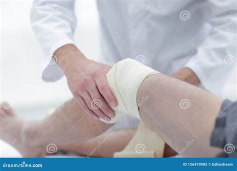 Doctor Treats Wound On The Patient S Leg In A Clinic Room Stock Image