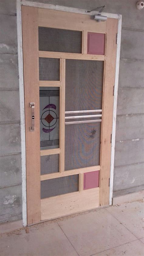 A Wooden Door With Glass Panels On It