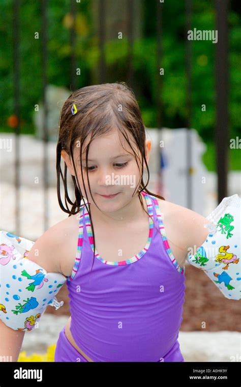 Pre K Female Wearing A Purple Swimsuit And Water Wings Stock Photo Alamy