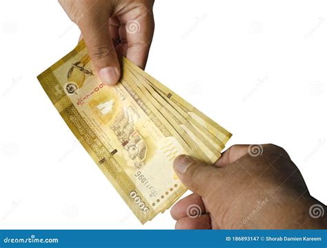 Sri Lankan Banknotes Of 5000 Making A Payment And Receiving Hand