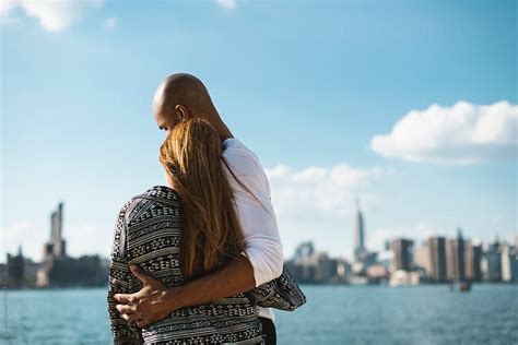 Young Couple Standing Against Manhattan Skyline By Simone Wave
