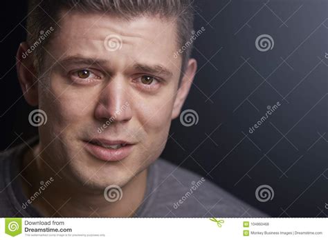 Close Up Portrait Of Upset Young White Man Looking To Camera Stock