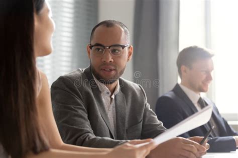 Male Employee Talk With Female Coworker At Workplace Stock Photo