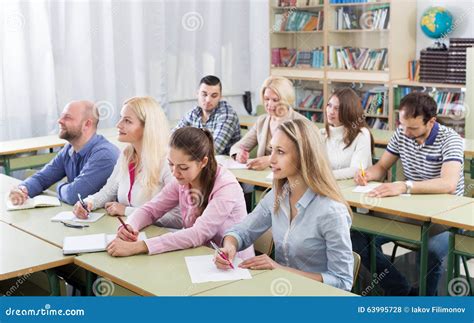 Adult Students Writing In Classroom Stock Photo Image Of Professional