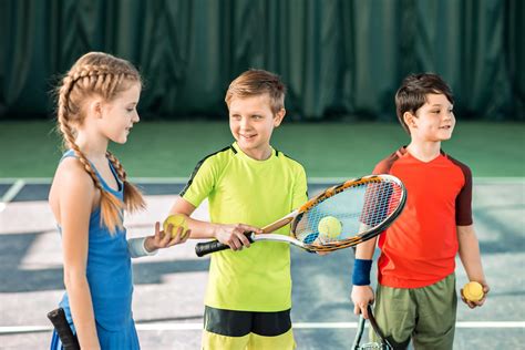 Happy children playing tennis on playground - Australian Fundraising