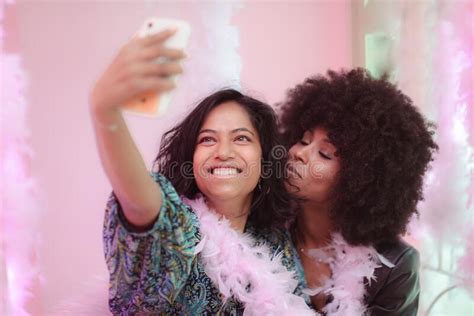 Cheerful Female Interracial Couple Taking Selfie With Smartphone Having Fun Together Stock