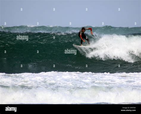 Surfer Riding Large Waves Off Porthmeor Beach St Ives Cornwall Stock