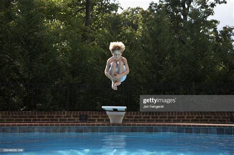 Boy Jumping Into Pool High Res Stock Photo Getty Images