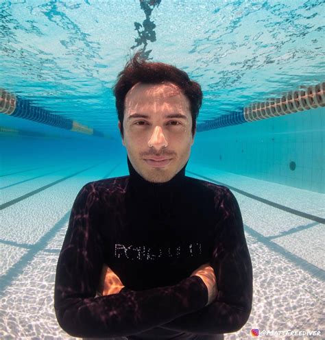 Underwater Men Breatholding Barefaced Underwater In Wetsuit