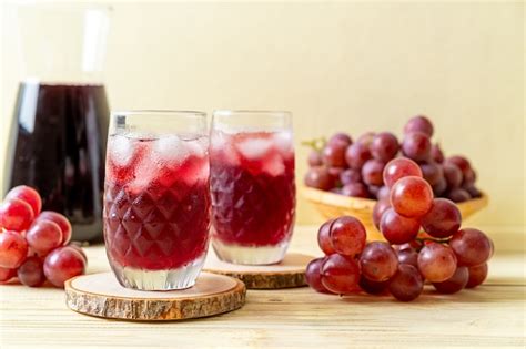 Free Photo Side View Of Black Grape Juice In Glass And Bowl Of Red