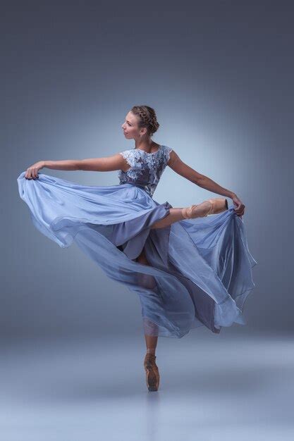 free photo the beautiful ballerina dancing in long blue dress on blue background